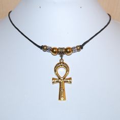 Ankh Cross Necklace,Ankh Cross,Ankh Cord Necklace,Choker Necklace,Men,Women,Spiritual,Ethnic Necklace,Coker Necklace,Gift Necklace Length in the picture shown is 18 inches (fits average people), if you would buy a different size please choose the length, i will custom made your size. Pendant Size: Approx. 1.50 x 2 inches. *   *   *   *   *   *   *   *   *   *   *   *   *   *   *   *   *   *   *   *   *   *   *   *   *   *   *   *   *   *   *   *   *   * COMBINE: Buy more items no extra charge fo Amulet Style Ankh Necklace In Brass, Symbolic Ankh Brass Necklace, Bohemian Ankh-shaped Bronze Jewelry, Bronze Ankh Bohemian Jewelry, Handmade Ankh Gold Necklace, Spiritual Metal Charm Necklaces, Brass Ankh Necklace For Gift, Bronze Ankh Metal Jewelry, Bronze Ankh Necklace