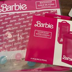 the package is pink and has white lettering on it, along with other packaged items