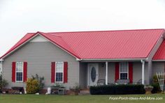 a gray house with red shutters on the front