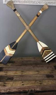 two wooden paddles are sitting on top of a chest