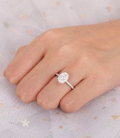 a woman's hand with a diamond ring on it