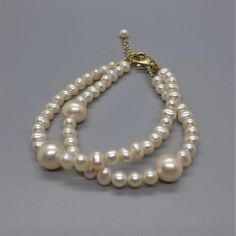 I don't typically make bracelets since they are so hard to make to "standard" wrist sizes. But I'm going to try and see if I can make bracelets that my customers like.  This bracelet is 7.5 inches long with a one inch gold filled extender chain.  These very luminous pearls are two sizes: 5mm and 10mm and the clasp is gold filled lobster claw.  My wrist is 6.5 inches and it fits me fine, also with extender chain if it needs to fit a larger wrist. Remember, all pearl surfaces are soft and may be likely to scratch if not careful. Classic Adjustable Hypoallergenic Gold Bracelet, Classic Adjustable White Charm Bracelet, Classic White Adjustable Charm Bracelet, Classic Adjustable Beaded Bracelets For Anniversary, Adjustable Double Strand Bracelet As Gift, Adjustable Double Strand Bracelet For Gift, Gold Bracelets With Round Beads And Extender, Adjustable Jubilee Pearl Bracelet For Anniversary, Classic Adjustable Hypoallergenic Pearl Bracelet