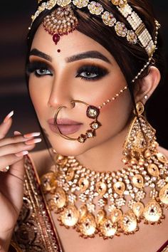 a woman with makeup and jewelry on her face