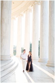 an engaged couple holding hands in front of the lincoln memorial