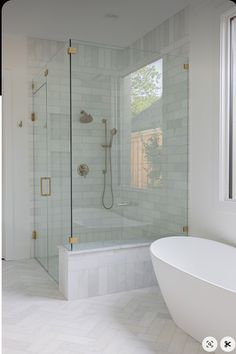 a bathroom with a tub, shower and window