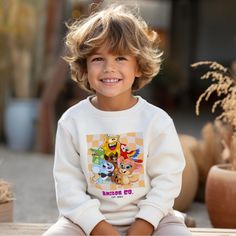 Hey there, cool kid (and awesome grown-ups Cartoon Friends)! Searching for that perfect combo of cozy and cute for your little rockstar? Look no further than our Amigos Cartoon Friends Youth Crewneck Sweatshirt!  Crafted to wrap your kiddos in ultimate softness while keeping their style game strong, this sweatshirt is like a warm hug from their favorite cartoon buddies! Just pop it on for instant smiles and non-stop comfort.  Perfectly snug, it's made for endless adventures, dreamy nap times, an Playful Cartoon Print Sweatshirt For Playtime, Playful Crew Neck Sweatshirt With Character Print, Playful Graphic Print Sweatshirt For Playtime, Playful White Sweatshirt With Character Print, Playful Graphic Print Sweatshirt, Cute Crew Neck Sweatshirt For Playtime, Fun Cartoon Print Sweatshirt, Playful Cartoon Print Sweatshirt, Playful White Sweater With Graphic Print