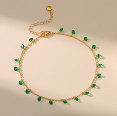 __ ~ G R E E N - G E M S T O N E - A N K L E T ~ __ This beautiful and unique Green Gemstone Anklet is the perfect gift for her! This delicate and dainty anklet features single green gemstones that dangle and sparkle with every movement.  The striking contrast between the sleek gold and the precious green stones will be cherished and admired, it's a perfect addition to any wardrobe. Whether you're wearing it to a special occasion or just as an everyday accessory, this unique anklet is sure to make a statement. ~  W H A T ~  Y O U ~  W I L L ~  R E C I E V E  ~  ~  1 x Chosen Green Gemstone Ankle Bracelet ~  Free Shipping With Every Order ~  Free Money Back Guarantee For 30 days ~ Replacement Warranty For 45 days ~ 100% Handmade Jewellery To Help Support Our Dream - S I Z E ~ G U I D E  ~ E Gemstone Anklet, Green Gem, Geometric Type, Ankle Chain, Gold Anklet, Copper Style, Chain Fashion, Green Gems, Everyday Accessories