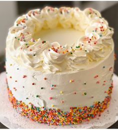 a cake with white frosting and sprinkles