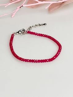 Experience timeless elegance with our handmade bracelet, decorated with faceted 3 mm ruby beads. This exquisite piece of jewelry has a length of 17 cm and an additional extension of 4 cm to ensure a perfect fit. The bright red rubies are not only a real eye-catcher, but also carry a deep symbolic meaning. Rubies are known to strengthen the heart, promote passion and energy, and increase self-confidence. This bracelet is not only a stylish accessory, but also a powerful symbol of love and vitalit Elegant Ruby Beaded Bracelets With Gemstones, Elegant Ruby Gemstone Beaded Bracelets, Elegant Ruby Gemstone Beads Bracelets, Elegant Red Faceted Beaded Bracelets, Ruby Bracelet, Ruby Beads, Ruby Jewelry, Everyday Accessories, Handmade Bracelet