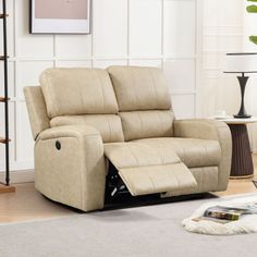 a beige reclining sofa in a living room with white walls and carpeting on the floor