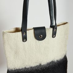 Sturdy, durable, and beautiful our Eclipse Hand Felted Tote bag is a perfect bag for your everyday life or a gift for a loved one. The entire bag, including the stunning ombre dye job, is hand made by a skilled team of craftsmen in South Africa. Artisan Black Bag For Daily Use, Artisan Bucket Bag Tote For Everyday, Everyday Artisan Satchel Bag, Artisan Rectangular Bag For Everyday, Artisan Everyday Tote Shoulder Bag, Artisan Rectangular Everyday Bag, Artisan Black Bag With Leather Handles, Artisan Black Bags With Leather Handles, Artisan Natural Color Everyday Bag