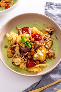 two bowls filled with food on top of a table