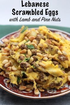 a plate filled with eggs and beans on top of a table