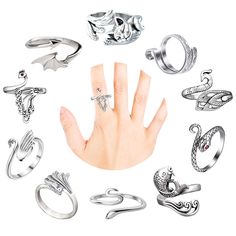 a woman's hand surrounded by many different types of rings and knucks