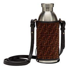 a brown and black bag with a silver bottle on it's side, sitting next to a lanyard strap