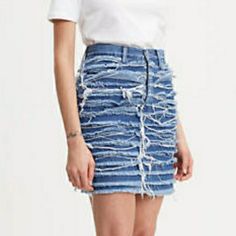 Levis Heritage Sz 24 Layered Fringe Big E Levi's Denim Skirt Crafted From Premium Denim, This High Rise Skirt Flatters Your Shape The Denim Is Washed And Shredded Before Being Bleached To Create A Surreal Texture Layered Fringe Made From Lightweight Denim Style # 677710000 Color: Saddle Up - Medium Wash High Rise Slim Fit 100% Cotton Denim Zip Fly Getting Dressed Shouldn’t Feel Like A Moral Dilemma. Our High Sustainability Standards Reduce Our Impact On The Planet, Better The Lives Of Apparel Wo Levi's Spring Mini Skirt, Trendy Levi's Short Denim Skirt, Levi's High Rise Mini Skirt For Spring, Trendy Levi's Mini Skirt, Trendy Levi's Mini Skirt For Spring, Levi's Mini Skirt For Spring, Levi's Fitted High Rise Mini Skirt, Levi's High Rise Fitted Mini Skirt, Levi's High-rise Denim Skirt