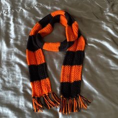 Orange And Black Yarn Knitted By Hand To Create This Beautiful 1970’s Aesthetic Scarf. Black And Orange Crochet, Aesthetic Scarf, Colorblock Scarf, Poncho Wrap Shawl, Scarf Aesthetic, Grey Poncho, Color Block Scarf, Chunky Knit Scarves, S Aesthetic