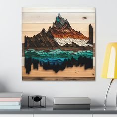 a painting hanging on the wall above a desk with a lamp and bookshelf