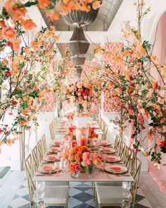 a long table with flowers and candles on it