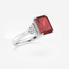 Step into the spotlight with this gorgeous ruby three stone ring, crafted with a breathtaking radiant cut. This showstopper will draw admirers in with its mesmerizing red color, while the unique faceting creates a dazzling display of scintillation. Complemented by diamond side stones, this ring strikes the perfect balance between bold and timeless. Engagement Ring Platinum, Three Stone Ring, Pearl And Diamond Earrings, Engagement Rings Platinum, Three Stone Engagement, Three Stone Engagement Rings, Radiant Cut, 14k White Gold Ring, Pearl Diamond