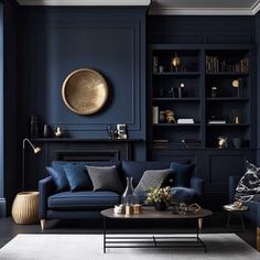 a living room with dark blue walls and furniture