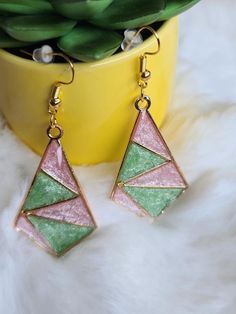 Elevate your style with these stunning handmade resin pink and green dangle earrings that beautifully capture the essence of elegance. The vibrant combination of pink and green creates a striking and eye-catching accessory, perfect for adding a bold touch to your everyday look. -crafted with UV Resin, Alloy Hypoallergenic All earrings are handmade by me and there may be minor variations. Colors may vary slightly from photos. Contact me if you have any questions.  Care instructions: Clean with a Trendy Green Geometric Jewelry, Trendy Geometric Green Jewelry, Elegant Green Resin Earrings, Pink Triangle Jewelry For Gifts, Pink Triangle Jewelry For Gift, Pink Triangular Jewelry For Gifts, Green Geometric Jewelry For Gifts, Pink Geometric Earrings, Handmade Green Geometric Earrings