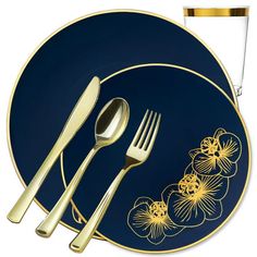 a blue and gold plate with flowers on it, next to a fork and knife