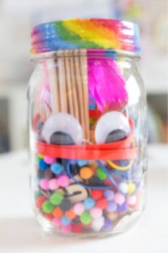 mason jar craft kits for kids to make with colorful beads and paper straws in a glass jar