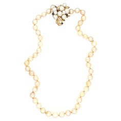 This timeless 18-inch pearl strand necklace showcases 48 lustrous cream-colored, round cultured pearls, each measuring 7 mm in diameter, offering a sophisticated and refined look. The necklace is completed with a unique pearl and sapphire clasp, featuring pearls ranging from 4.5 to 6.5 mm and accented by 0.12 carats of vibrant blue sapphires, adding a touch of color and elegance to the clasp. Crafted in the 1970s and stamped "14K,” this necklace weighs 35.46 grams, providing a comfortable yet lu Elegant Single Strand Cream Pearl Necklace, Elegant Cream Single Strand Pearl Necklace, Classic Pear-shaped Pearl Necklace, Elegant Cream Single Strand Necklace, Classic Cream Pearl Necklace With Pearl Charm, Vintage Akoya Pearl Drop Necklace, Classic Cream Pearl Chain Necklace, Elegant Cream Jewelry With Pearl Pendant, Elegant Cream Pearl Necklace For Formal Occasions