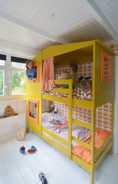 a child's bedroom with bunk beds and toys on the floor