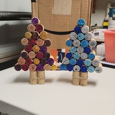 two wine cork trees made to look like they are standing next to each other on a table