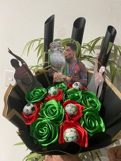 a man holding a bouquet of flowers with soccer balls and trophies in the center on it