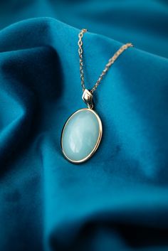 Vintage 9ct Yellow Gold Teal Chalcedony Enhancer Pendant. Metal: 9ct Yellow Gold   Stone: Chalcedony   Size: 20.5mm x 30mm     Price: $725.00     007-00036     Please view all photos as they form part of the description.   This item will be presented in one of our gorgeous boxes and carefully packaged should you wish to have it posted to you. Luxury Oval Jade Necklaces, Formal Gold Jade Necklaces, Formal Gold Jade Necklace, Luxury Yellow Gold Jade Necklaces, Luxury Yellow Gold Jade Necklace, Luxury Jade Necklaces For Wedding, Formal Yellow Gold Jade Necklace, Classic Yellow Gold Necklaces With Cabochon, Hallmarked Oval Jade Necklaces