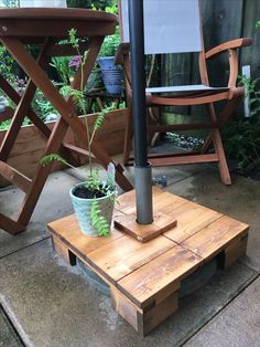 a potted plant sitting on top of a wooden coffee table next to a chair