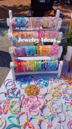 a table topped with lots of colorful bracelets