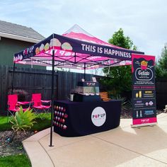 a pink and black tent sitting on top of a sidewalk