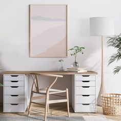 a white desk with two drawers and a plant on it in front of a large poster