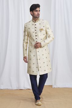 Cream sherwani in jacquard silk brocade base fabric featuring floral motifs and embellished buttons& collar. Paired with contrast navy blue churidar.
Component: 2
Neckline: Mandarin
Sleeve Length: Full
Fabric: Sherwani: Jacquard Silk Brocade; Pant: Dupion Art Silk; Lining: Faux Satin
Color: Beige
Front button down placket
Embellished button and collar
Note: The pocket square worn by the model is for styling purpose only - Aza Fashions Traditional Jacquard Sets For Formal Occasions, Elegant Jacquard Sets For Wedding, Traditional Jacquard Kurta For Wedding, Elegant Jacquard Kurta For Festive Occasions, Festive Jacquard Kurta For Wedding, Fitted Jacquard Sets For Wedding, Elegant Jacquard Traditional Wear For Festive Occasions, Elegant Jacquard Traditional Wear For Wedding, Festive Jacquard Traditional Wear For Wedding