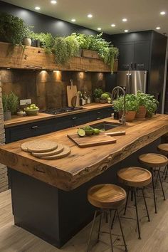 a large kitchen with an island made out of wood and surrounded by potted plants