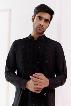 Black short kurta with tonal dori embroidery. Paired with a slim fit pant.
Components: 2
Pattern: Embroidery
Type Of Work: Dori, Geometric
Neckline: Stand Collar
Sleeve Type: Full Sleeves
Fabric: Cotton Silk Blend
Color: Black
Other Details: 
Model height: 5ft 11inches, wearing size M
Occasion: Sangeet - Aza Fashions Traditional Embroidered Semi-formal Sets, Black Traditional Wear For Festive Semi-formal Occasions, Festive Embroidered Traditional Wear For Semi-formal Occasions, Semi-formal Embroidered Traditional Wear, Black Semi-formal Traditional Wear For Festive Occasions, Black Zari Work Kurta For Semi-formal Occasions, Semi-formal Resham Embroidery Kurta For Eid, Formal Embroidered Cotton Silk Kurta, Embroidered Semi-formal Traditional Wear For Diwali