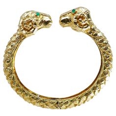 A hinged cuff bracelet by David Webb, made of 18k gold, features emerald. The bracelet designed as two ram heads facing each other. The rams can be interpreted as Aries astrological sign. The emerald is cabochon cut. About David Webb Bold, excessive, and uncompromising, David Webb jewelry pieces always make a statement. No matter if you are wearing Webb earrings, ring or necklace — rest assured you have a conversational piece that inevitably grabs attention. The designer drew his inspiration in Jeanne Toussaint, David Webb Earrings, David Webb Bracelet, Luxury 14k Gold Snake-shaped Jewelry, Luxury Vintage Green Cuff Bracelet, Astrology Signs Aries, Aries Bracelet, Scarab Bracelet Vintage, Stars D'hollywood