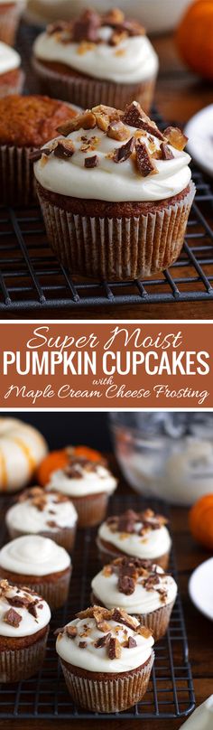 pumpkin cupcakes with cream cheese frosting and candies on the top are sitting on cooling racks