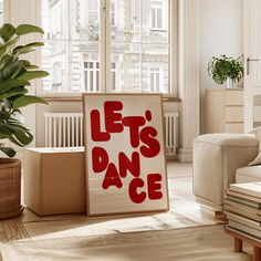 there is a sign that says let's dance next to a potted plant