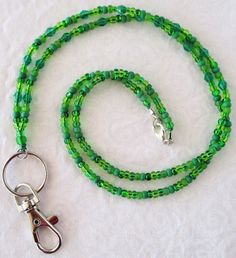 Green Beaded Lanyard This Green Beaded Lanyard can be used as a badge holder, an I.D. holder, or keychain necklace - it's a multi-use accessory for home or office! 30" in length, long enough to put on or remove overhead. It also has an easy-to-use lobster clasp for your convenience. It's made with green glass beads and strong C-Lon beading cord. Snap-on badge holder, clip, and keyring are included to keep your badges or keys ready when you need them. This Green Beaded Lanyard will ship to you in Adjustable Green Beaded Necklaces With Lobster Clasp, Adjustable Beaded Chain Lanyard For Gift, Adjustable Green Beaded Necklace With Lobster Clasp, Cheap Everyday Beaded Lanyards, Adjustable Green Lanyards As Gifts, Adjustable Beaded Blue Lanyards, Cheap Adjustable Green Lanyards, Keychain Necklace, Beading Cord