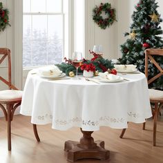 a dining room table set for christmas dinner