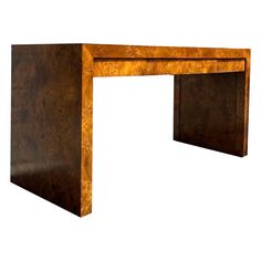 an art deco desk made out of burlwood with one drawer on the top