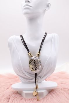 The "Metallic Gold and Silver Pendant with Dangling Stones and Multi Black Rope Necklace" combines a striking pendant crafted from both gold and silver metals, adorned with multiple dangling stones that catch the light with every movement. This intricate pendant is complemented by a necklace made of several strands of sleek black rope, adding a contemporary and bold contrast to the luxurious design. Length: 18” (18 extensions) Pendant: 2.26” (Length) 1.64” (Width) Closure: Lobster Claw Clasp Mat Adjustable Metal Rhinestone Pendant Necklace, Rhinestone Pendant Necklace With Adjustable Chain, Adjustable Metal Drop Necklace For Party, Metal Dangle Crystal Necklace For Party, Metal Crystal Dangle Necklace For Party, Silver Bohemian Rhinestone Necklace, Bohemian Silver Rhinestone Necklace For Gift, Bohemian Silver Rhinestone Necklace As A Gift, Party Metal Crystal Dangle Necklaces