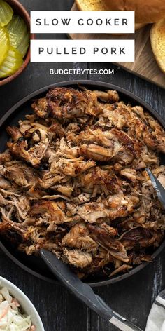 slow cooker pulled pork in a cast iron skillet with coleslaw and pickles