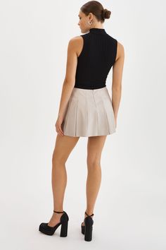 The Juliana Pleated Skirt is effortlessly feminine with its playful pleats and mini length. Pair it with sneakers and an oversized sweater for a casual look, or dress it up with knee-high boots for an evening ensemble. Chic Spring Tennis Skirt, Chic Accordion Pleats Mini Skirt For Fall, Fall Casual Skort With Accordion Pleats, Casual Tennis Skirt With Accordion Pleats For Fall, Casual Fall Tennis Skirt With Accordion Pleats, Chic Mini Tennis Skirt With Pleated Hem, Chic Pleated Skort For Day Out, Chic Pleated Short Skirt For Day Out, Chic Short Length Pleated Skirt For Day Out