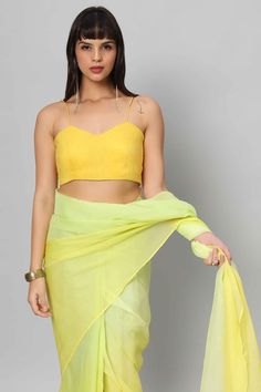 A true Yellow strappy blouse - where it with a matching saree or skirt or as a contrast piece! Product Features: Color: Yellow Fabric: Raw Silk with cotton lining Design - Spaghetti Straps with Pentagon Neckline Not padded Closure: Back Sizing: Not stretchable - margin of 2 inches inside seams for adjustments Occasion: Party, Wedding, Bridesmaid, Festive Product Type: Blouse Disclaimer: There will be slight difference in digital to actual image Elegant Yellow Organza Pre-draped Saree, Yellow Fitted Organza Pre-draped Saree, Semi-stitched Yellow Art Silk Pre-draped Saree, Yellow Semi-stitched Organza Saree, Lime Yellow Saree, Strappy Blouse, Draped Saree, Yellow Ombre, Yellow Saree